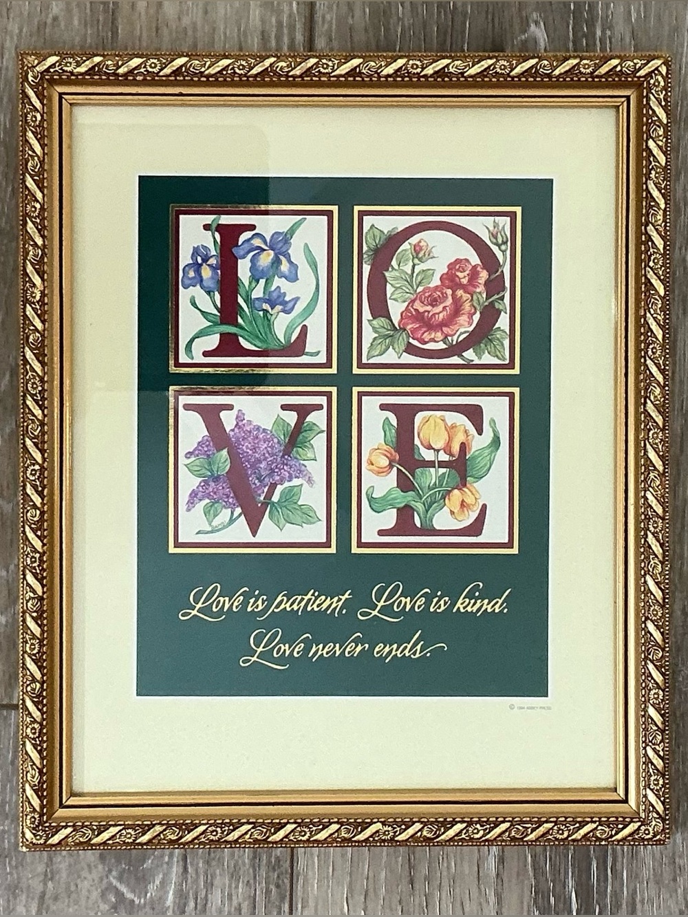 This is a 1994 Abbey Press "Love is Patient" framed floral lithograph print.